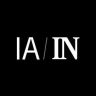 Logo com letras brancas 'IA / IN' em fundo preto. 'IA' sem serifa, 'IN' com serifa.